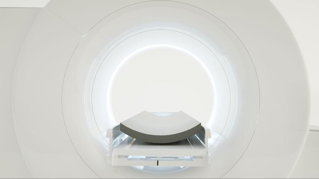白を基調とした清潔な部屋に設置された医療用MRI装置